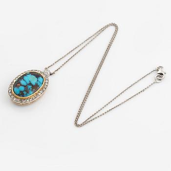 A turquoise pendant in platinum and 14K gold set with old- and rosecut diamonds.