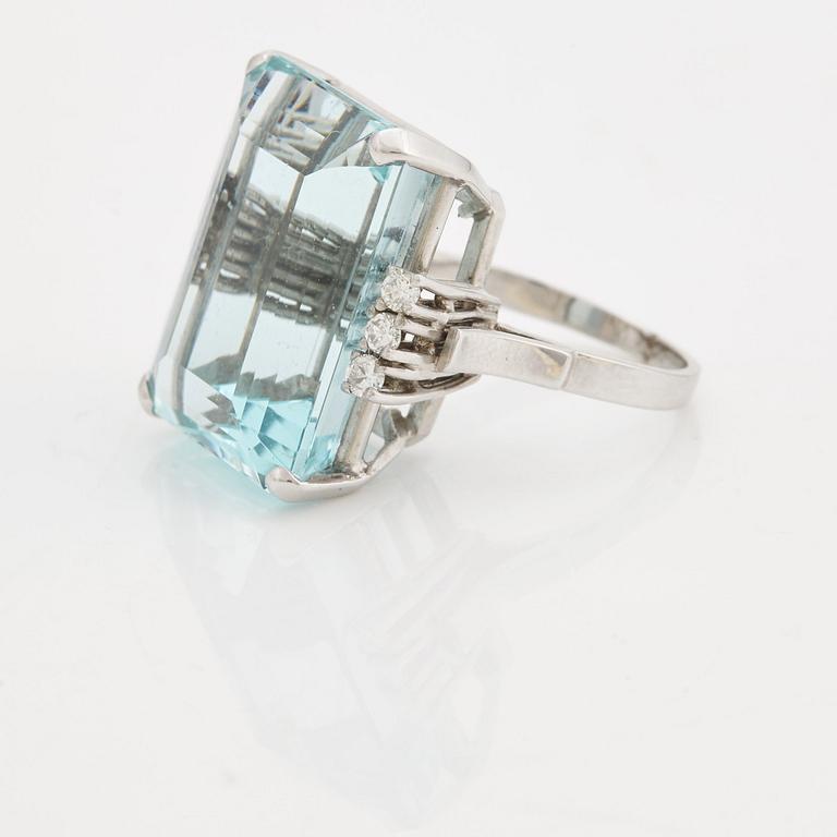 A emerald cut aquamarine and brilliant cut diamond ring.