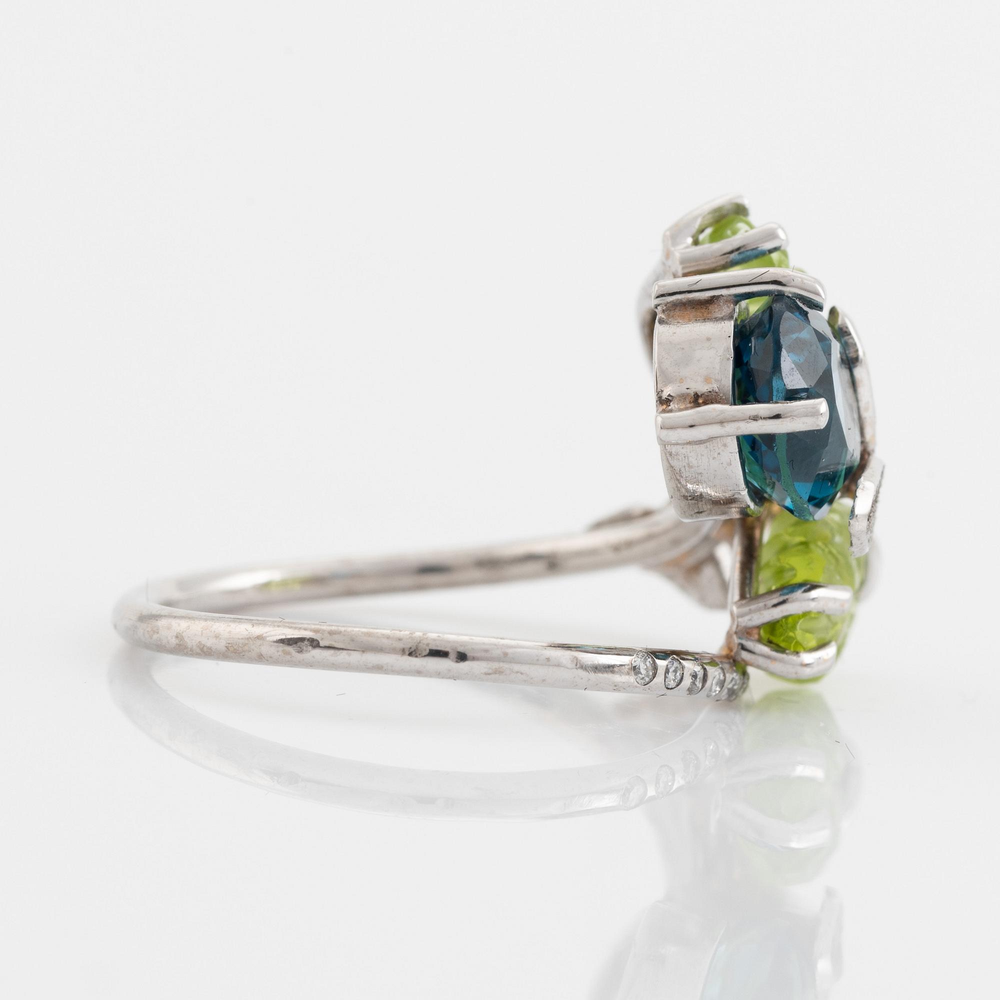Blue topaz, carved peridot leaf, brilliant cut diamond ring.