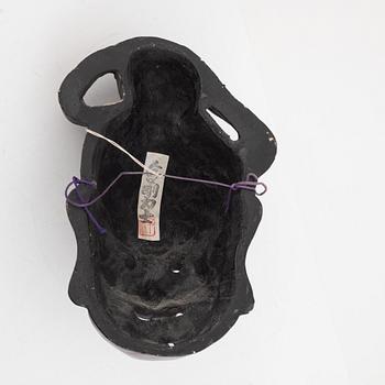 A Japanese lacquered wooden mask, 20th century. Signed.