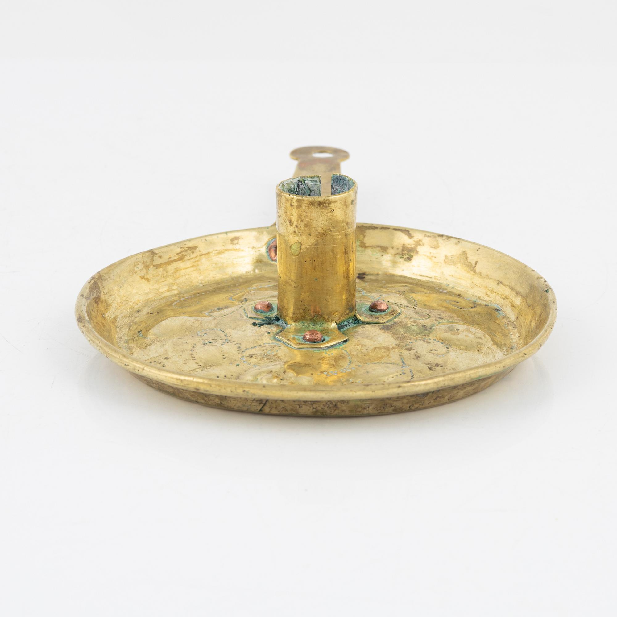 A repousse brass baroque candlestick, circa 1700.