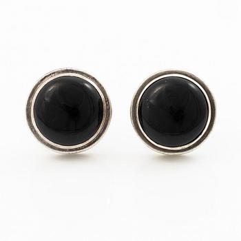 Cufflinks, a pair in silver with cabochon-cut stones.