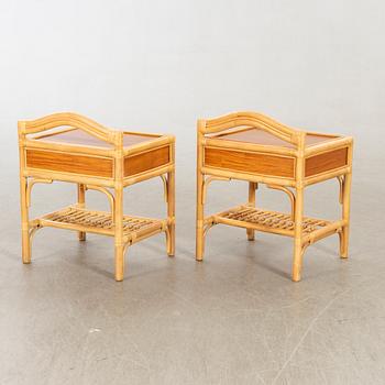 A pair of 1980s Dux rattan bedside tables.