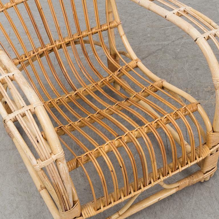A pair of mid 20th century rattan easy chairs.
