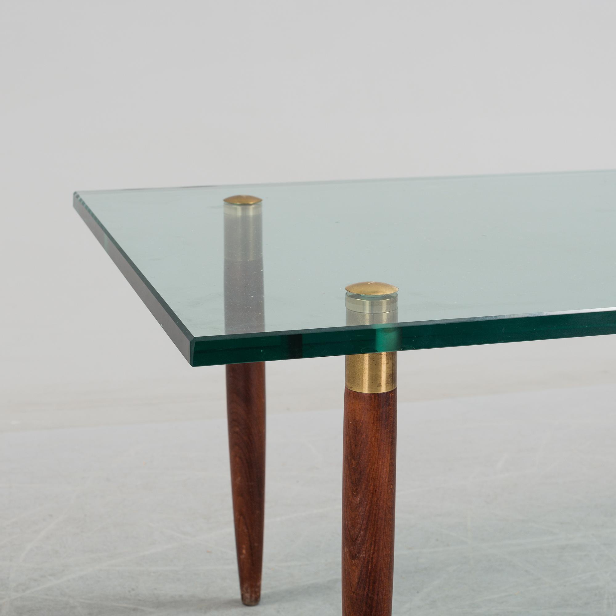 A 1960's glass sofa table.