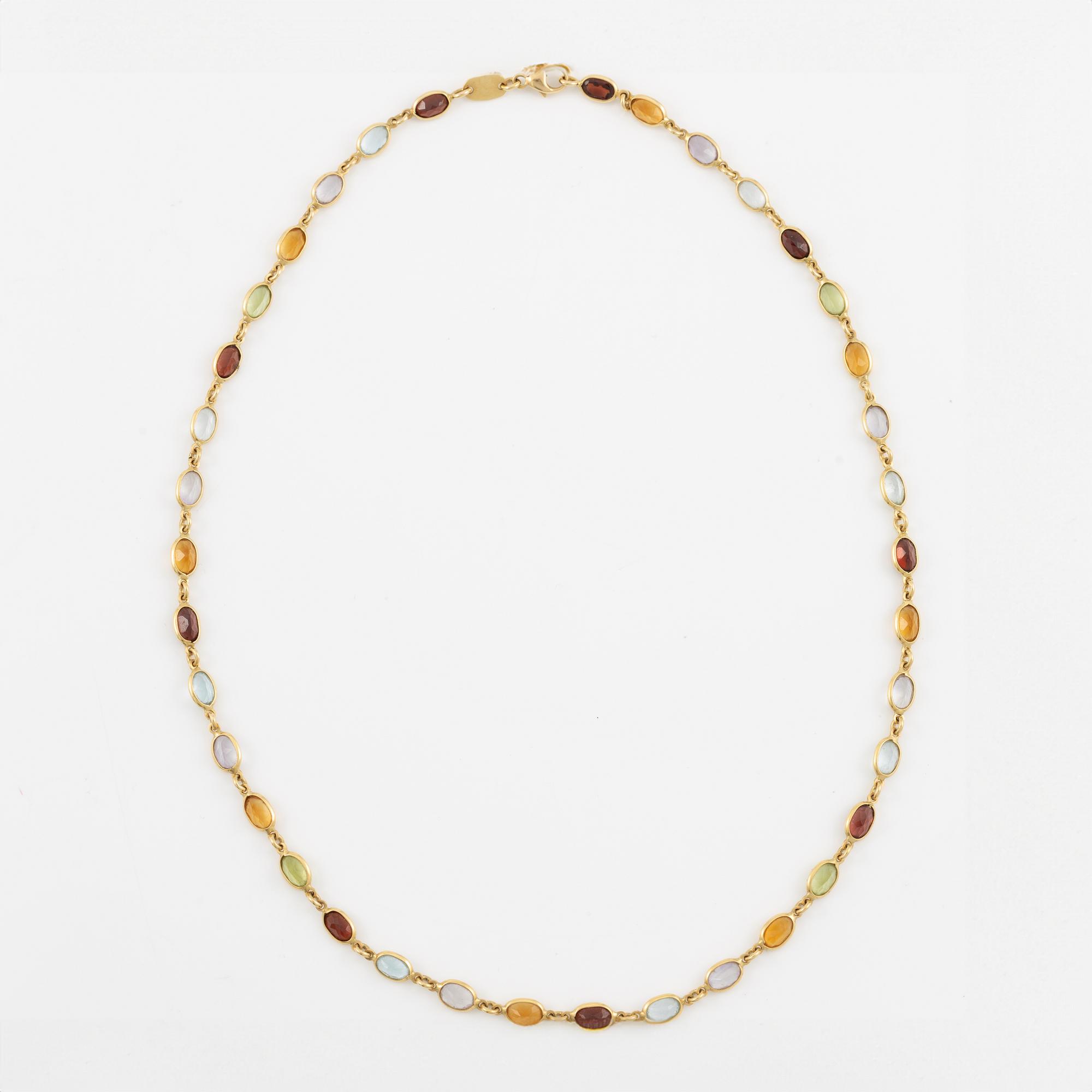 Necklace in 18K gold set with, among other stones, peridot, topaz, citrine, and amethyst.