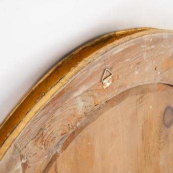 An oval mirror from around the year 1900.