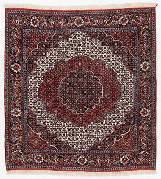 An Oriental rug, approx. 213 x 201 cm.