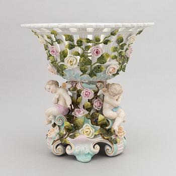 A pair of porcelain rococo style candelabra and a centerpiece bowl, Plaue, Germany, first half of the 20th century.