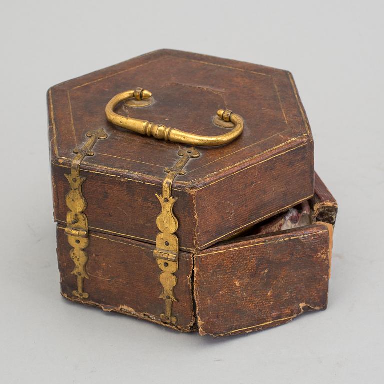 A gilded brass baroque travel clock from around 1700, with original case.