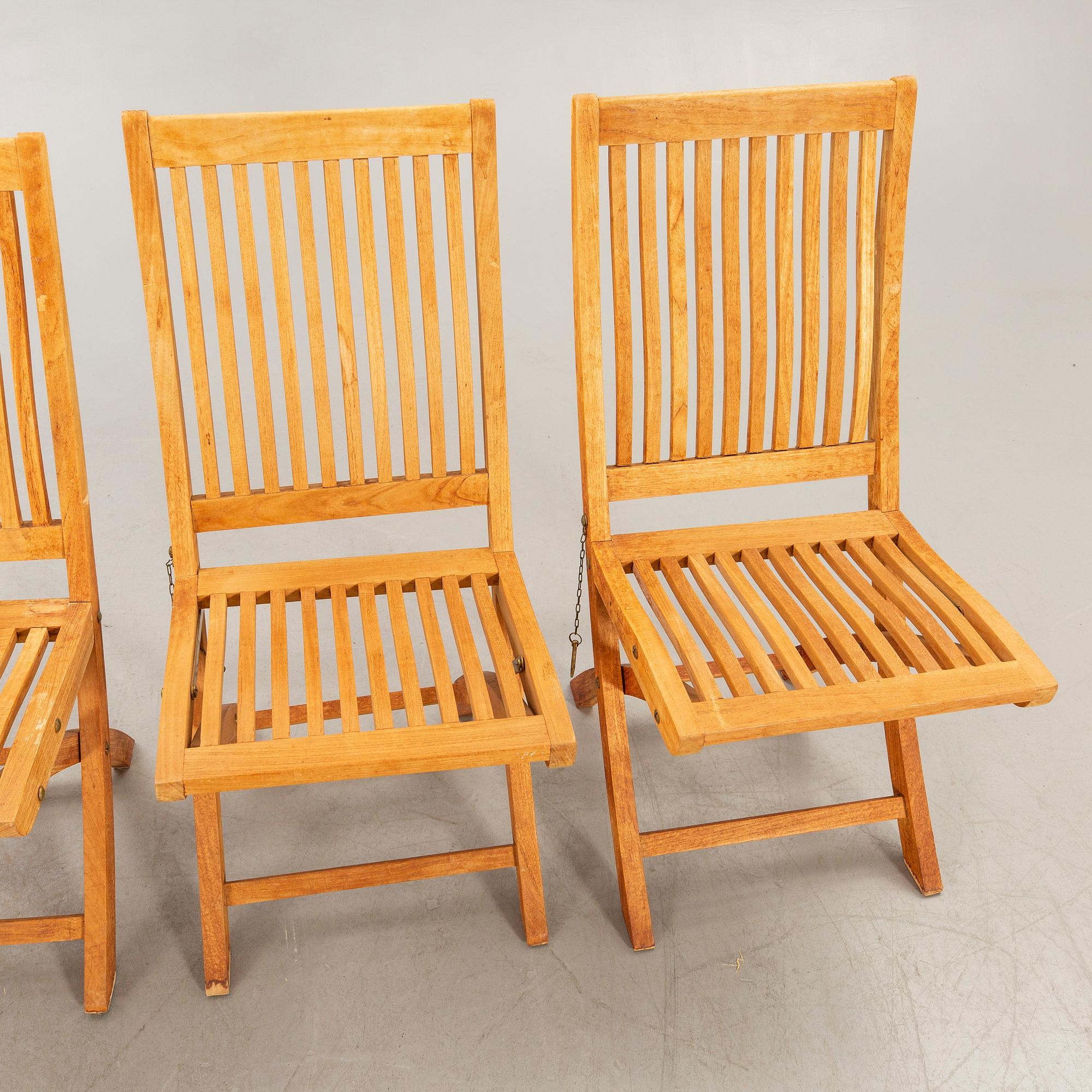 A set of four chairs and a table Royal teak and others, later part of the 20th century.