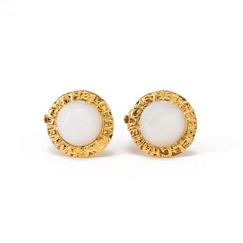 A pair of earclips by Chanel.