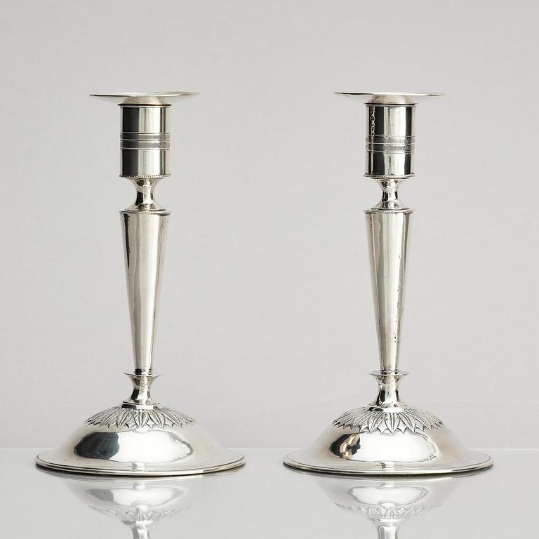 Two pair of early 19th century silver candlesticks, marks of Anders Lundqvist, Stockholm, Sweden 1819 and 1821.