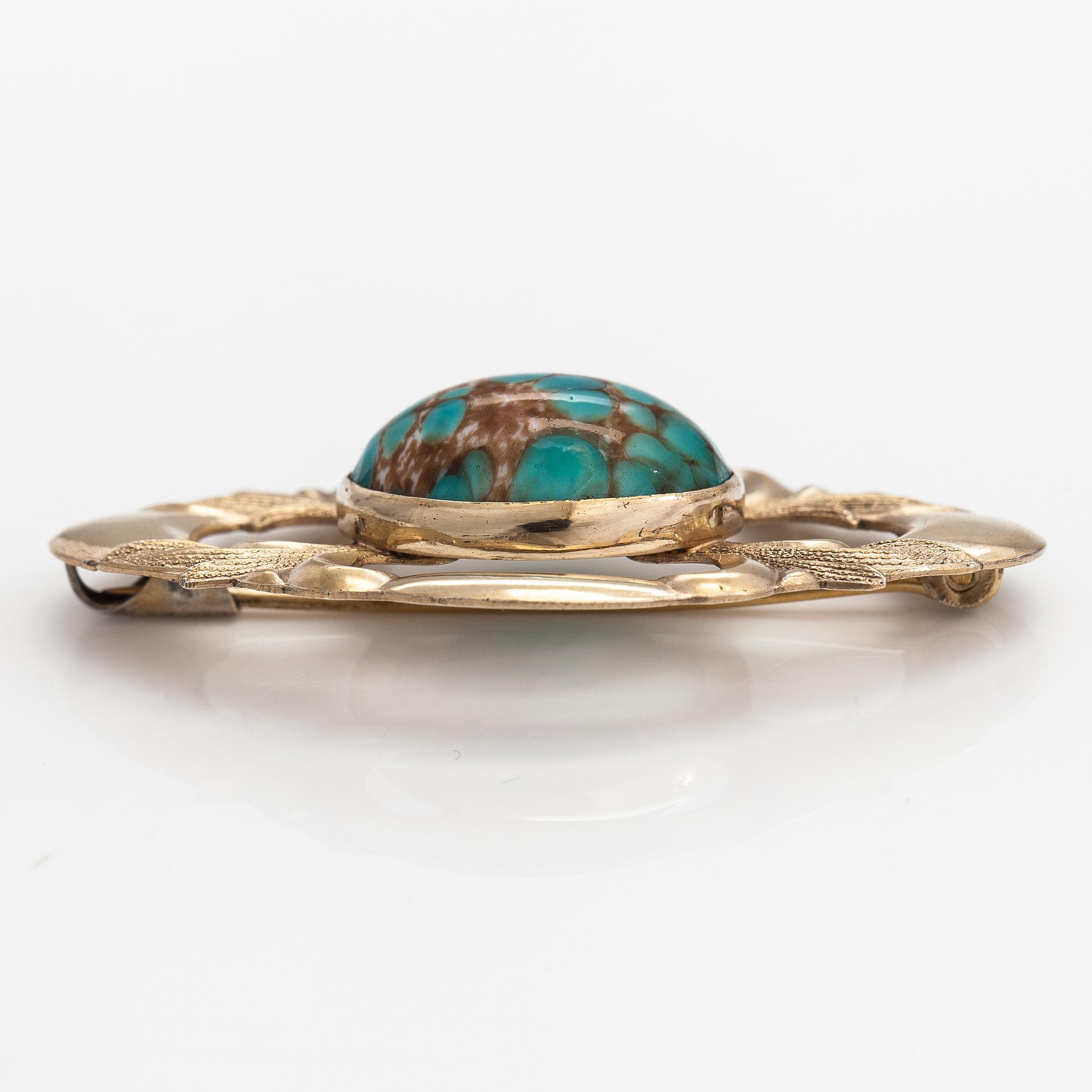 Elis Kauppi, A gilded silver brooch with a glass stone. Kupittaan kulta, Turku, 1940's.