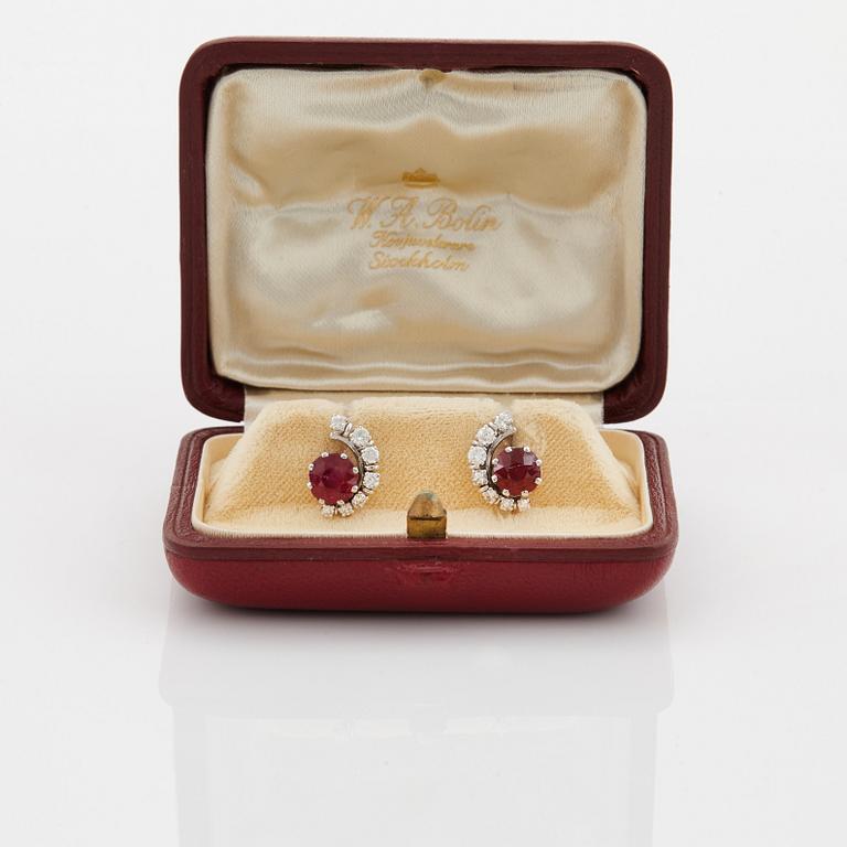 A pair of 18K white gold WA Bolin earrings set with faceted rubies and round brilliant- and eight-cut diamonds.