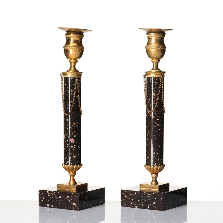 A pair of late Gustavian porphyry and gilt brass candlesticks, circa 1800.