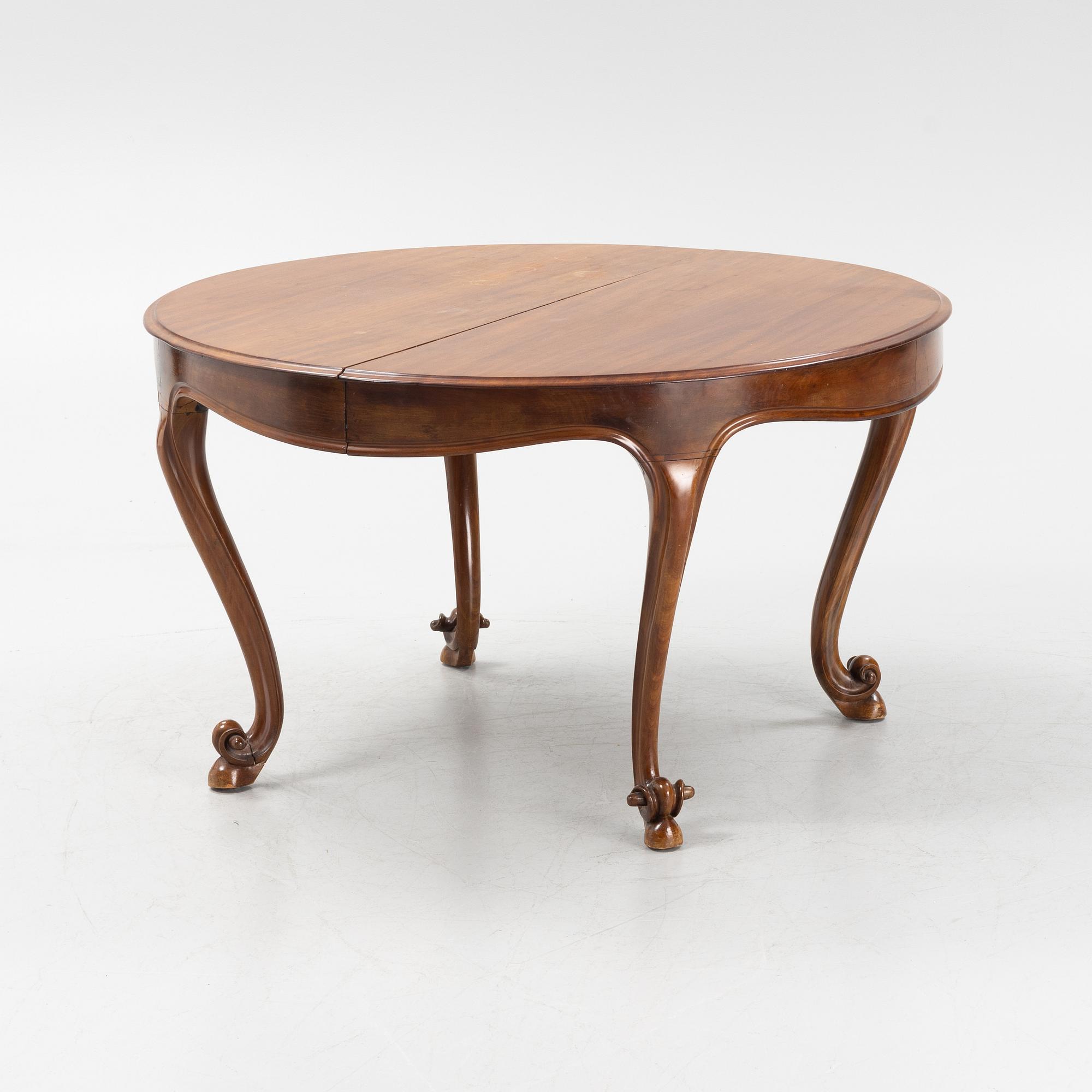 A mahogany rococo style dining table, 19th Century.