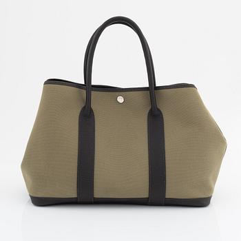 Hermès, a green canvas and brown leather 'Garden Party' bag.