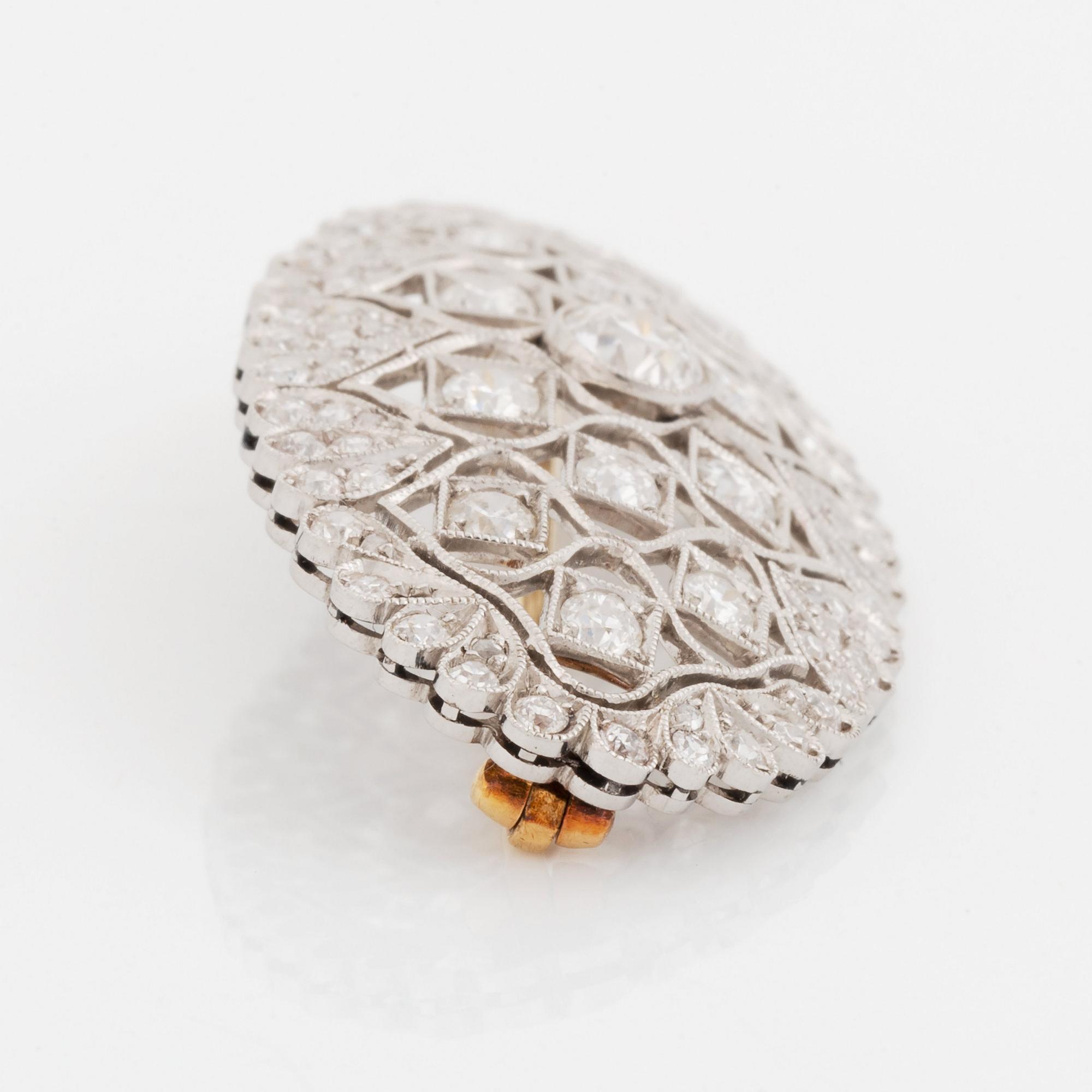 A platinum and gold brooch set with old-cut diamonds.