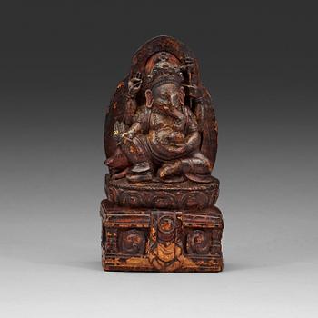 97. A carved wooden figure on Ganesha on a throne, Nepal, 19th Century or older.