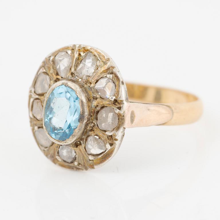 Ring in 14K gold with a faceted topaz and rose-cut diamonds.
