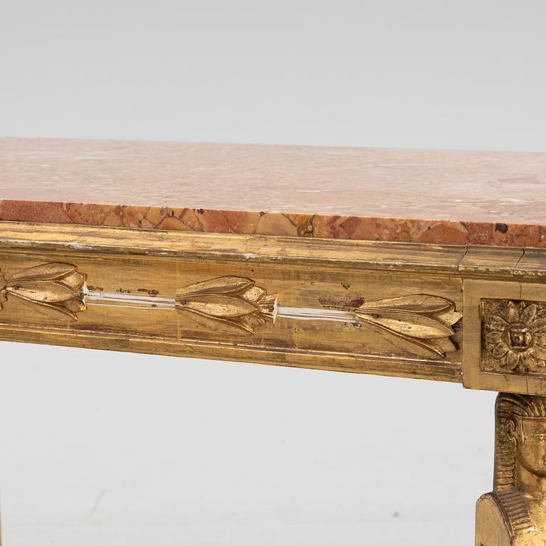 A gilt Empire style center table with a stone top.