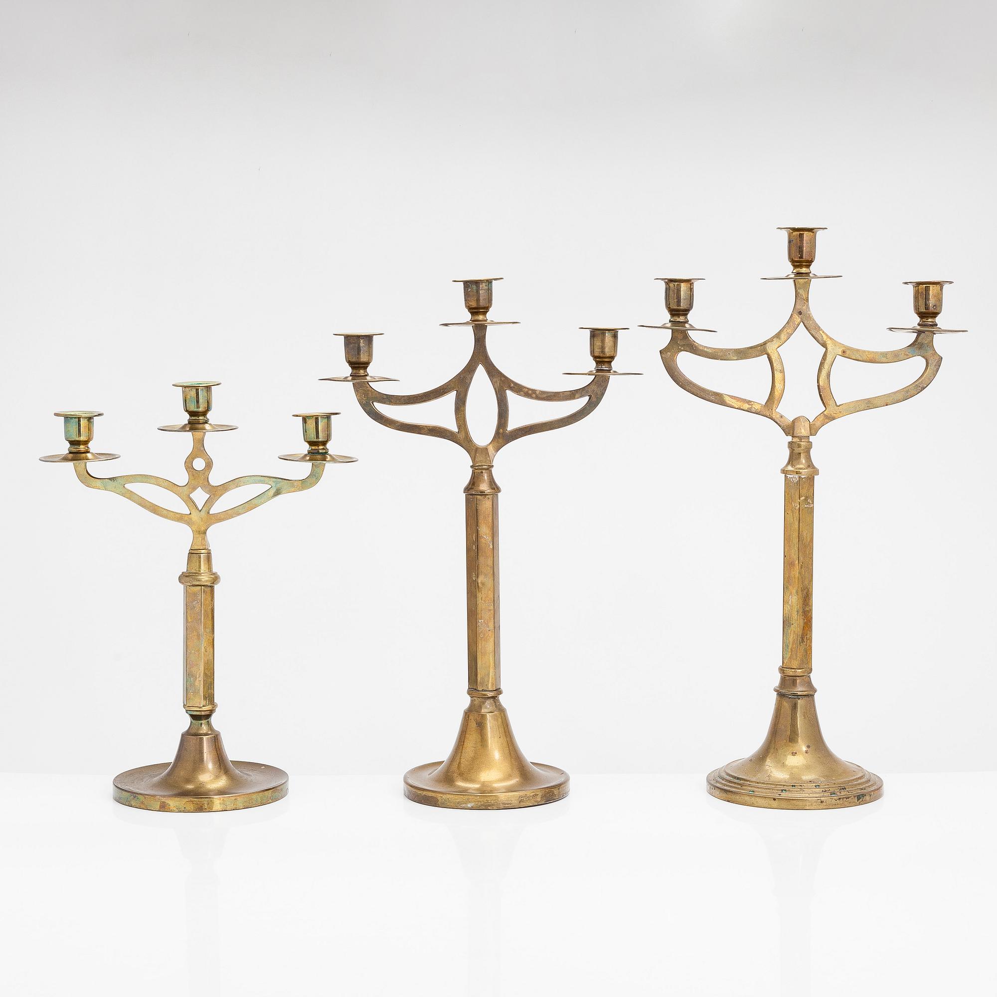Three brass candlesticks from the early 20th Century.