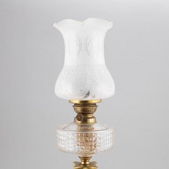 A brass oil lamp, ca 1900.
