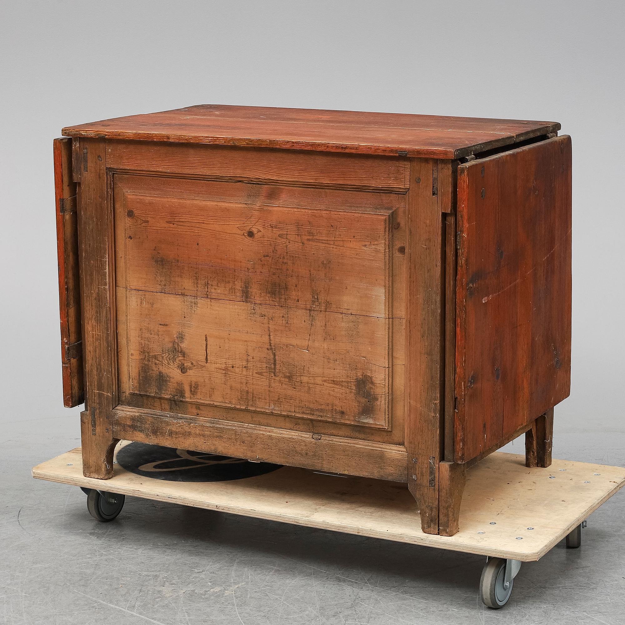 A 19th Century chest of drawers with a table top.