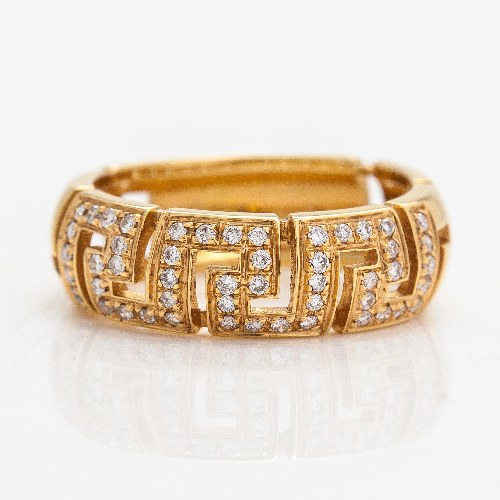 Versace, An 18K gold ring with diamonds ca. 0.12 ct in total. Marked Versace.