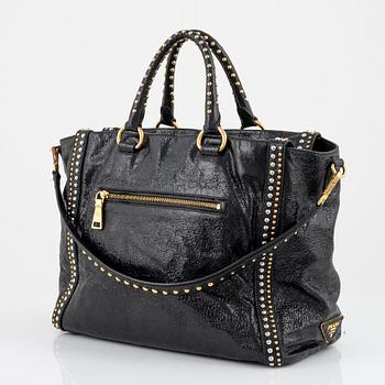 Prada, A black leather and gold stud bag.