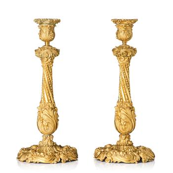 138. A pair of gilt-bronze rococo-revival candlesticks, later part 19th century.