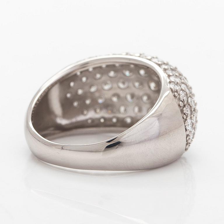 A platinum bombé ring with brilliant-cut diamonds.