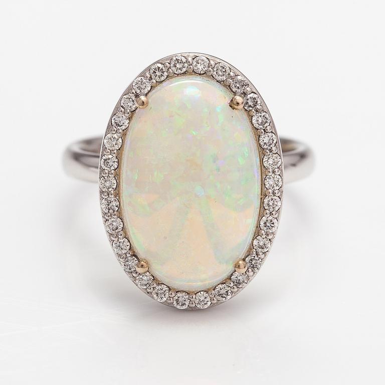 An 18K white gold ring with an opal ca. 4.64 ct and diamonds ca. 0.35 ct in total according to certificate.