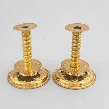 A pair of brass baroque style candlesticks, end of the 19th century.