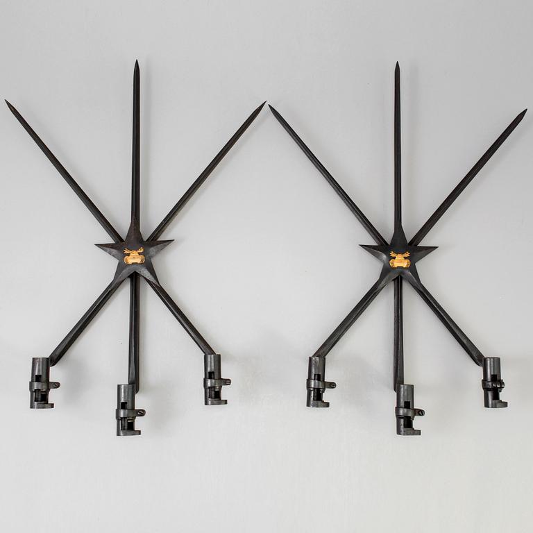 A pair of steel wall sconces made from bayonets, 20th Century.