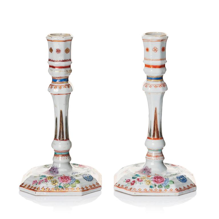 A pair of famille rose candles sticks, Qing dynasty, Qianlong (1736-95).