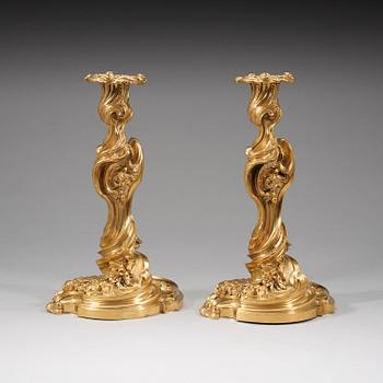 A pair of Louis XV 18th century gilt bronze candlesticks after the model by Juste-Aurèle Meissonnier.