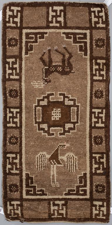 A RUG, a semi-antique Tibetan probably, ca 158 x 78 cm.