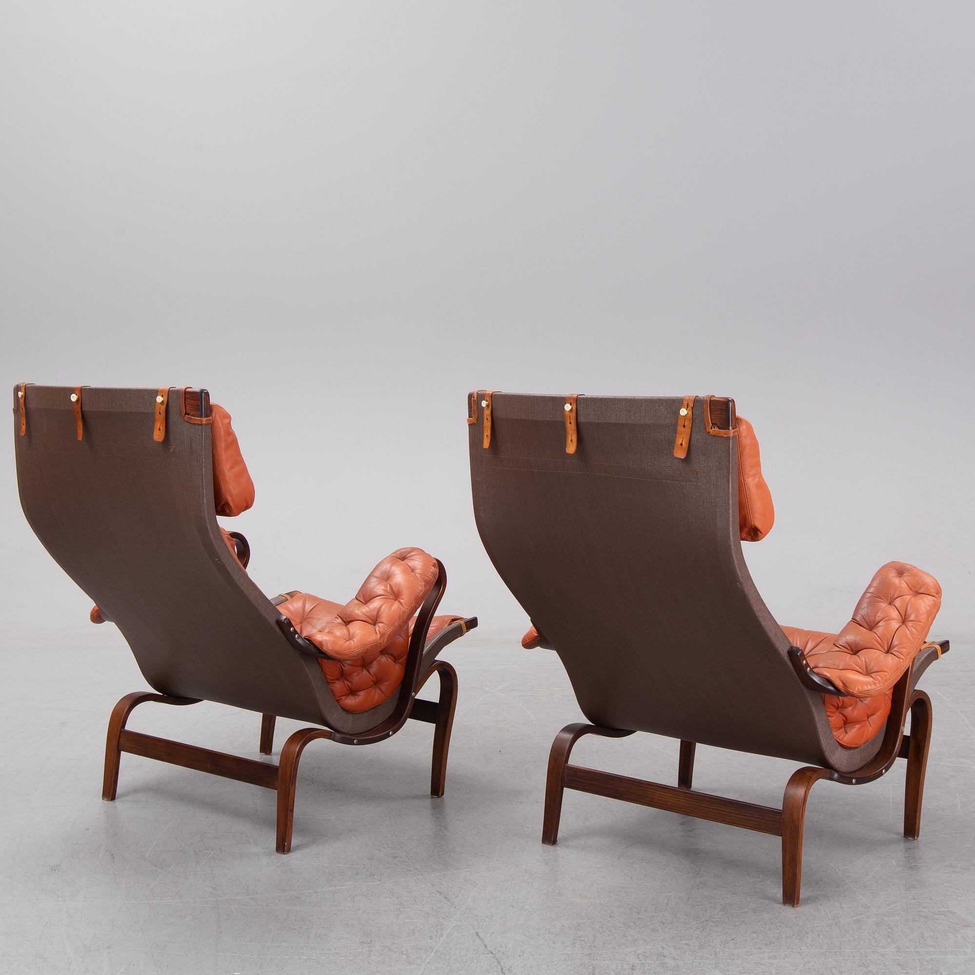 An end of the 20th Century pair of 'Pernilla' easy chairs with leather upholstery by Bruno Mathsson for DUX.