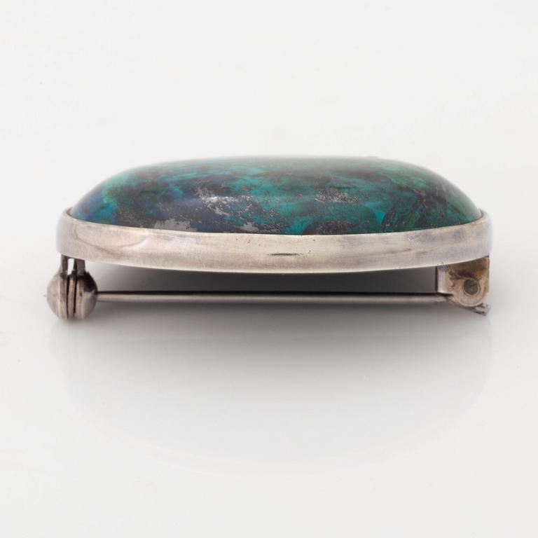 Cecilia Johansson, silver and cabochon cut green blue stone.