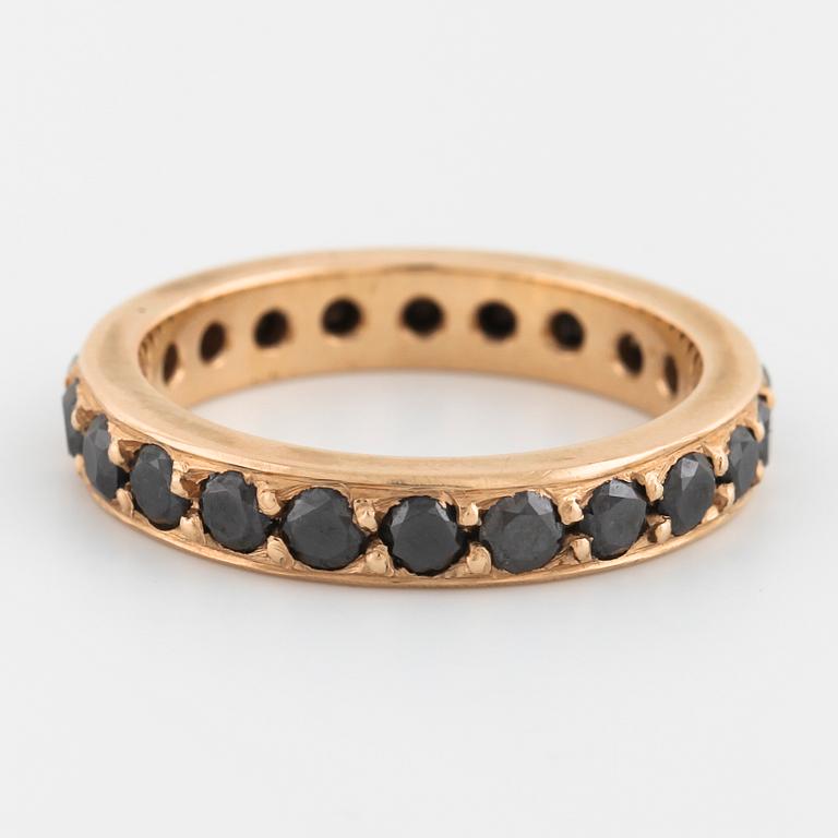 A brilliant cut black diamond ring.