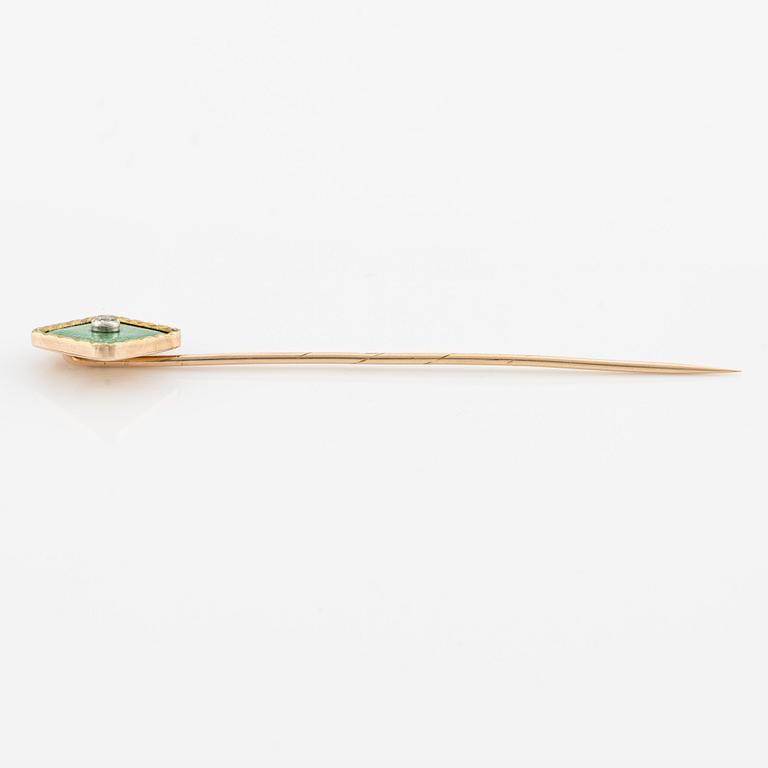 A tie pin 14K gold and guilloché enamel with a diamond.