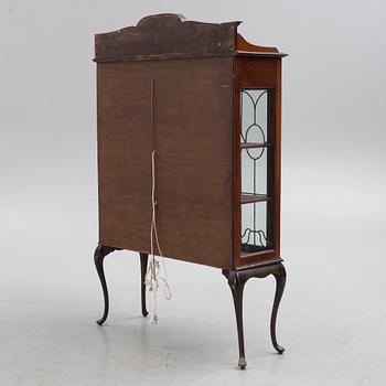 A display cabinet, England, early 20th century.