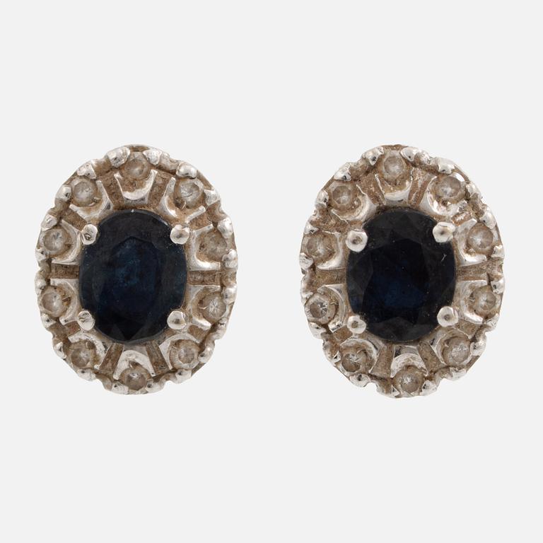 Earrings, a pair of 18K white gold set with dark sapphires and small brilliant-cut diamonds.