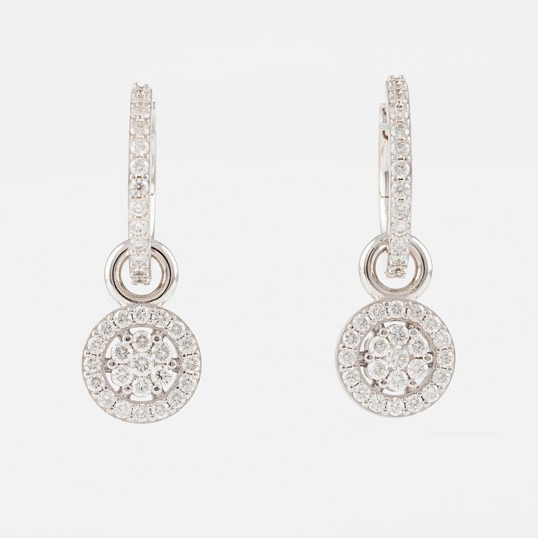 A pair of 18K gold earrings with round brilliant-cut diamonds.