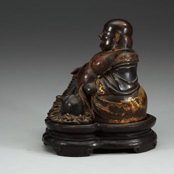 A lacquered bronze figure of Budai, Qing dynasty (1644-1912).