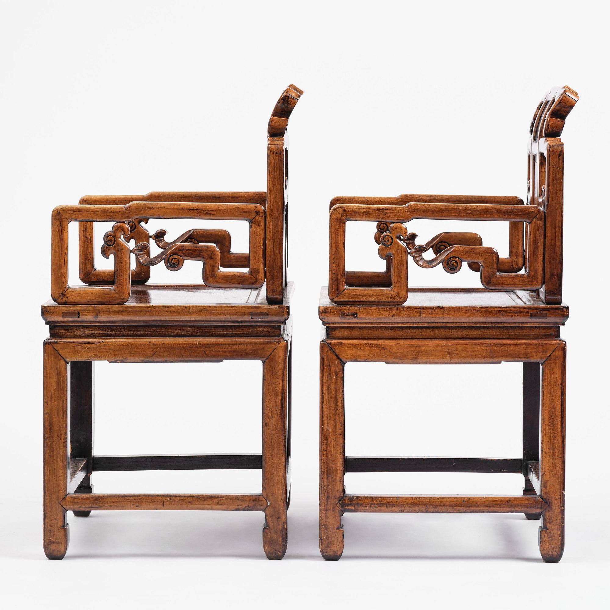 A pair of hardwood armchairs, late Qing dynasty.