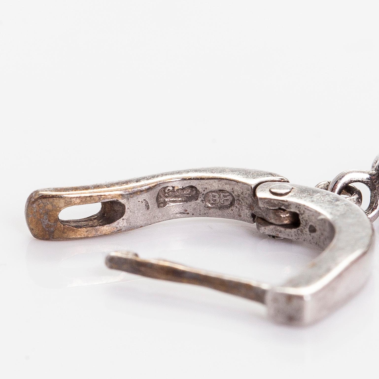 A pair of 14K white gold earrings, set with brilliant-cut diamonds and pink tourmalines.