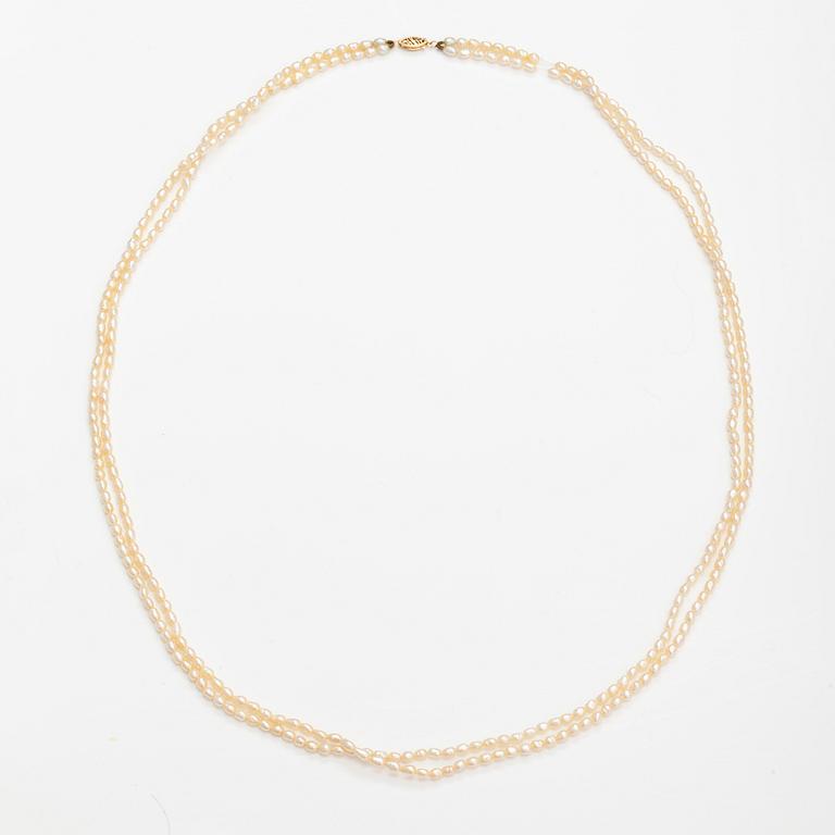 A two-strand pearl collier with cultured pearls and 14K gold clasp.